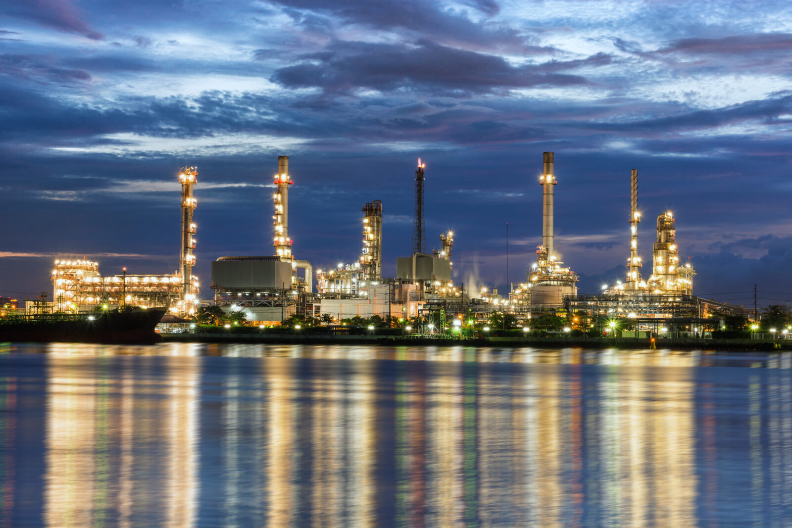 Twilight of oil refinery plant with cloudy background.
